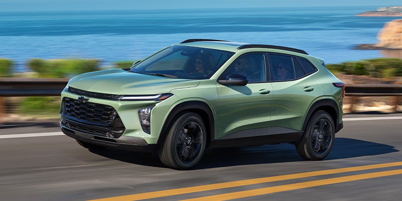 Light green 2025 Chevy Trax driving on road